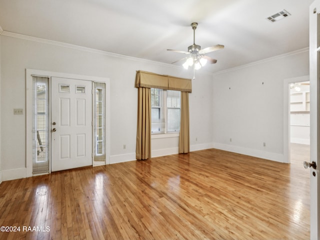 entryway featuring light wood-type flooring, ceiling fan, and crown molding