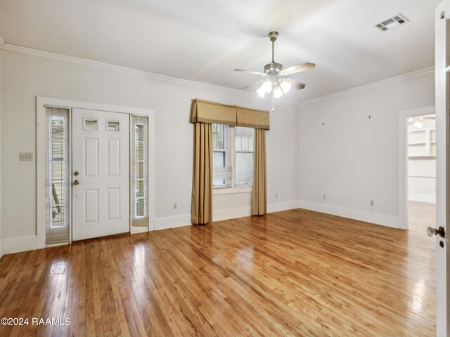 243 W Grolee St, Opelousas, LA 70570 - unfurnished living room featuring ceiling fan, light wood-type flooring, crown molding, and baseboards