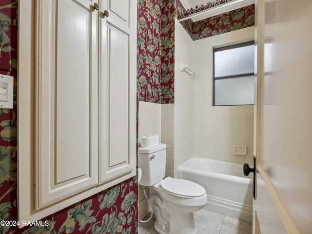 bathroom with tiled shower / bath combo, tile patterned floors, and toilet