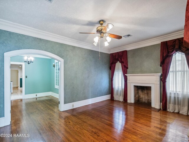 243 W Grolee St, Opelousas, LA 70570 - unfurnished living room with wood finished floors, a ceiling fan, arched walkways, ornamental molding, and a fireplace