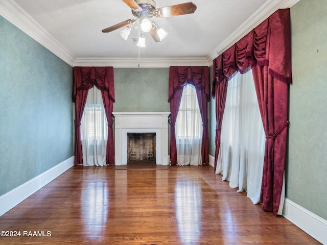 unfurnished living room with ceiling fan, wood-type flooring, ornamental molding, and plenty of natural light