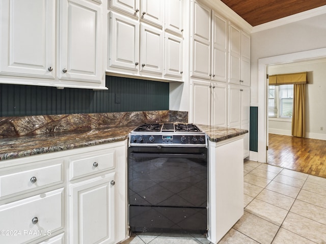 kitchen with light hardwood / wood-style floors, dark stone counters, white cabinets, black range oven, and wooden ceiling