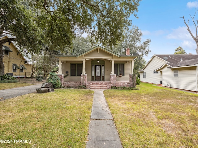 bungalow-style house with a front yard and a porch