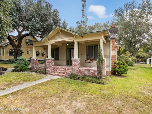 243 W Grolee St, Opelousas, LA 70570 - view of front of house featuring a porch and a chimney