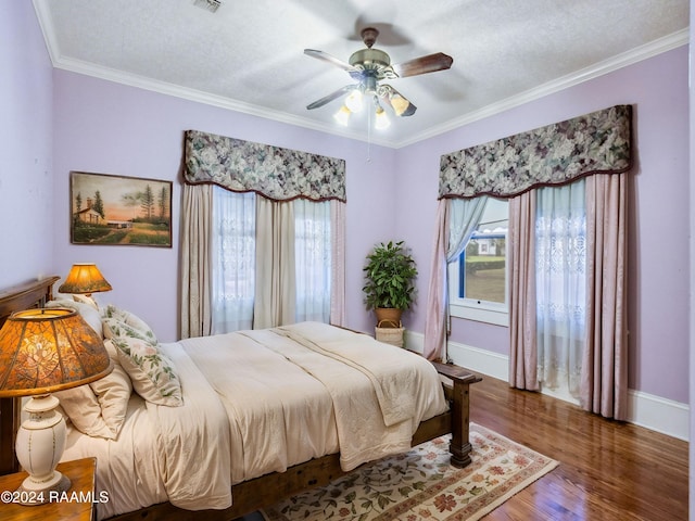 bedroom featuring hardwood / wood-style flooring, ceiling fan, a textured ceiling, and crown molding