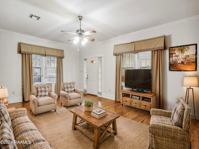 243 W Grolee St, Opelousas, LA 70570 - living room with light wood finished floors, crown molding, baseboards, and a ceiling fan