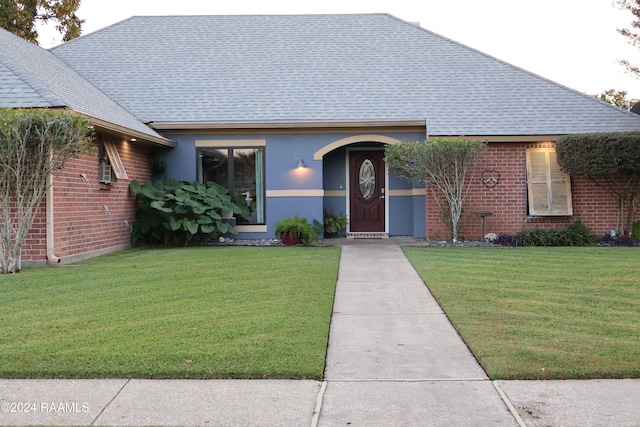 bungalow-style home with a front yard