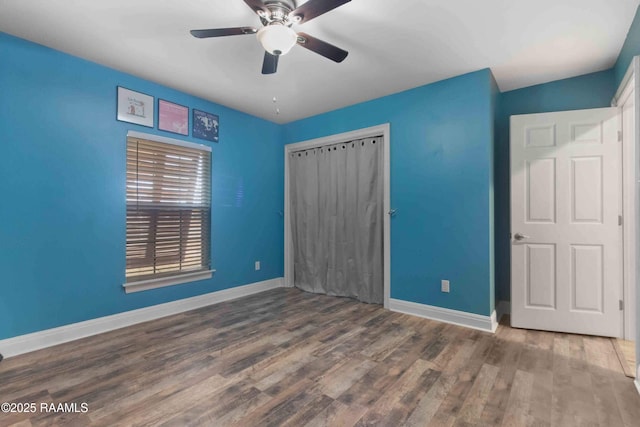 unfurnished bedroom featuring ceiling fan, hardwood / wood-style floors, and a closet