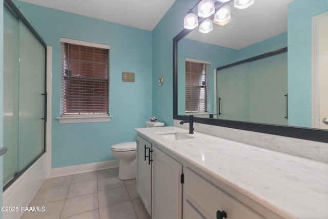 full bathroom featuring vanity, combined bath / shower with glass door, tile patterned floors, and toilet