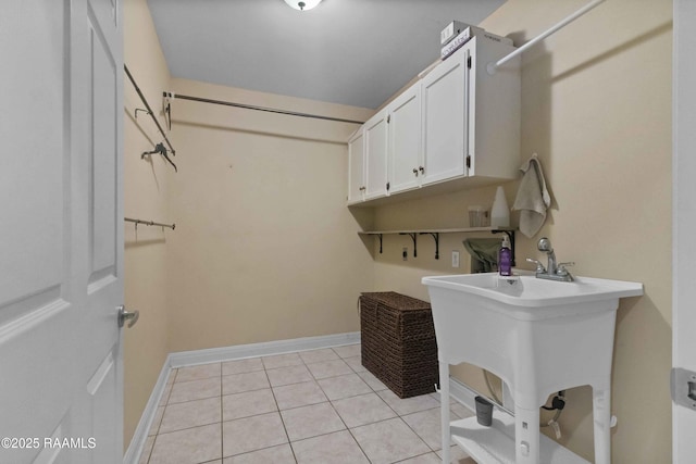 laundry room with sink and light tile patterned floors