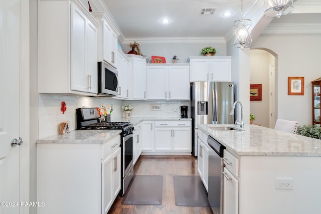 kitchen with hanging light fixtures, stainless steel appliances, sink, light wood-type flooring, and white cabinets