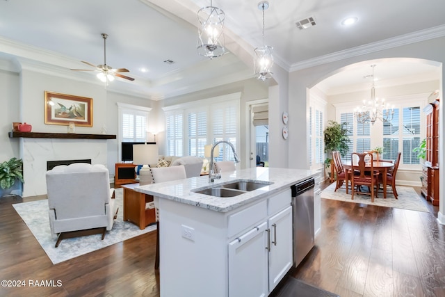 kitchen featuring white cabinets, a center island with sink, dark hardwood / wood-style flooring, pendant lighting, and sink