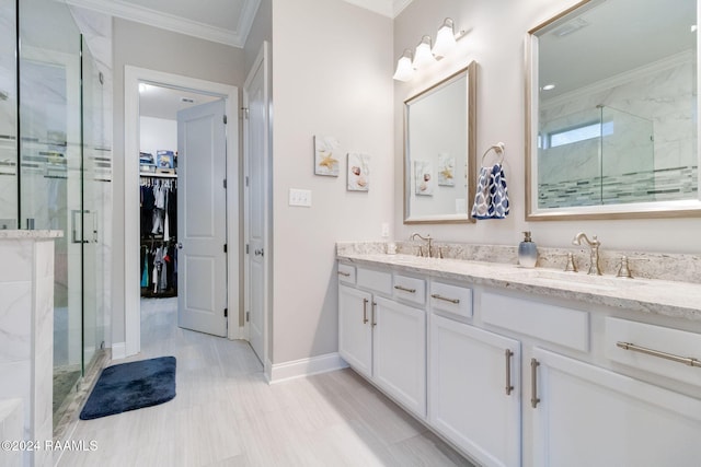 bathroom with vanity, crown molding, and a shower with shower door