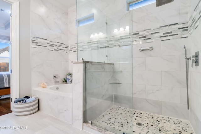 bathroom with independent shower and bath and a wealth of natural light