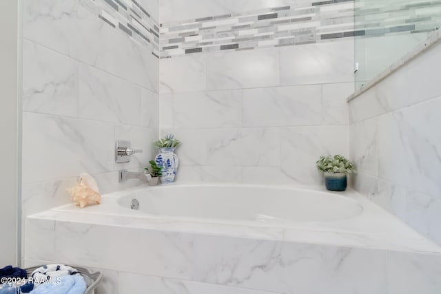 bathroom with tiled tub