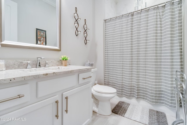 bathroom with vanity, a shower with shower curtain, and toilet