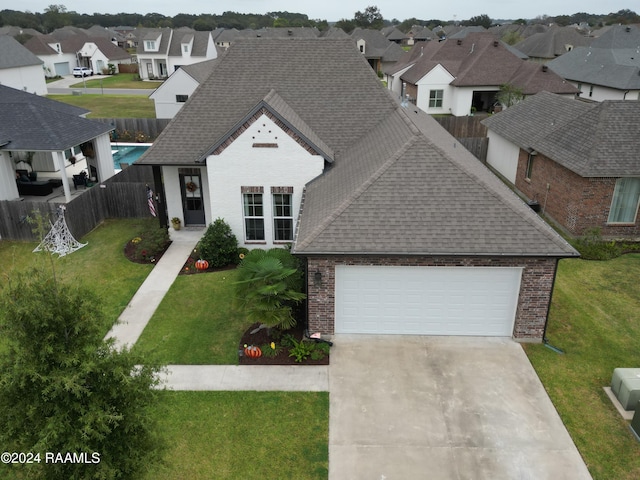 view of front of home with a front yard and a garage