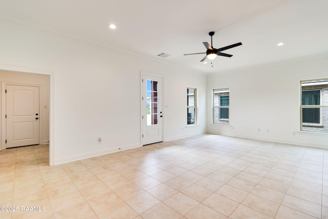 empty room with ceiling fan, ornamental molding, and light tile patterned floors