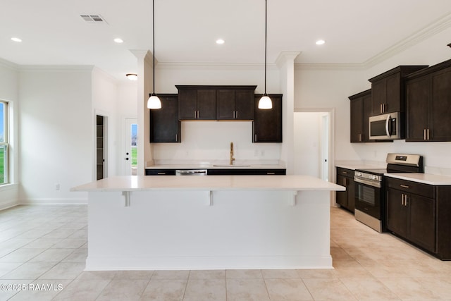 kitchen with sink, a center island, pendant lighting, stainless steel appliances, and dark brown cabinetry