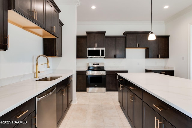 kitchen with pendant lighting, stainless steel appliances, ornamental molding, and sink