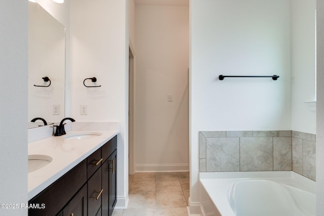 bathroom featuring tile patterned floors, a tub, and vanity