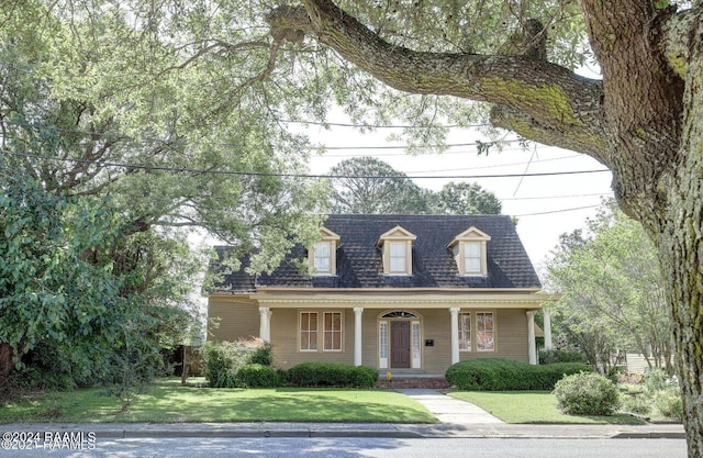 cape cod-style house with covered porch and a front lawn