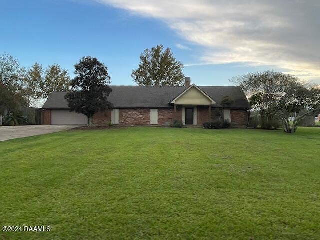 ranch-style house with a front yard and a garage