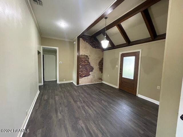 interior space featuring lofted ceiling with beams, dark hardwood / wood-style floors, and ornamental molding