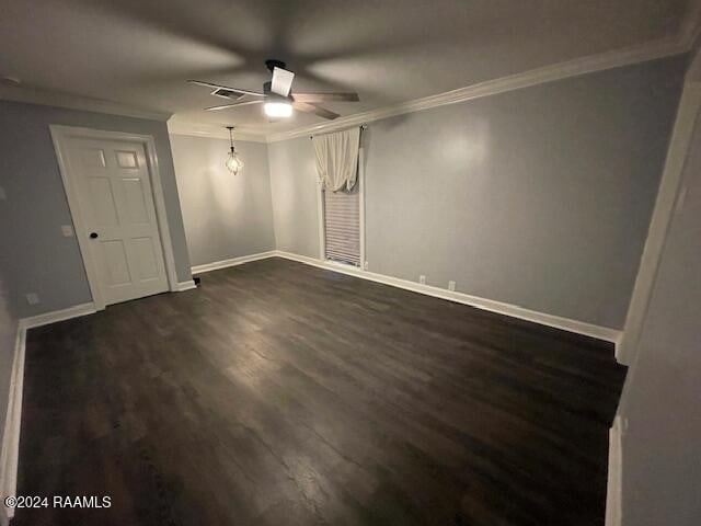 spare room featuring dark hardwood / wood-style floors, ceiling fan, and ornamental molding