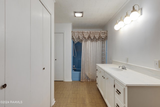 bathroom featuring shower / bath combo with shower curtain and vanity