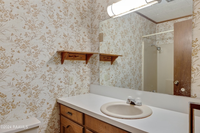 bathroom featuring walk in shower, vanity, and toilet