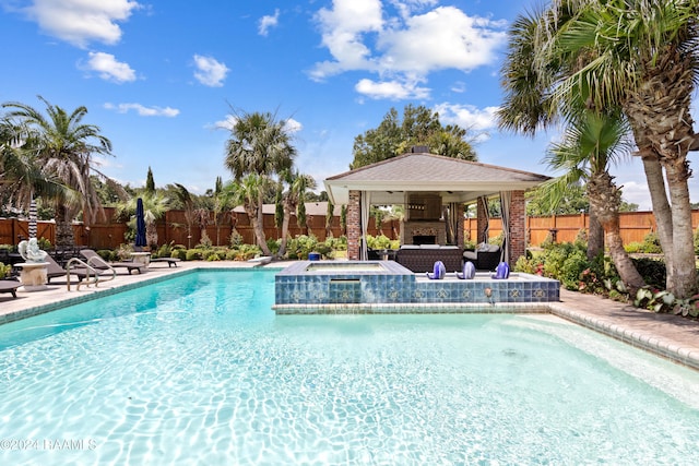 view of pool with a patio area and an in ground hot tub