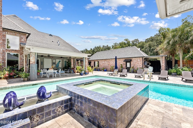 view of swimming pool featuring ceiling fan, a patio, and an in ground hot tub