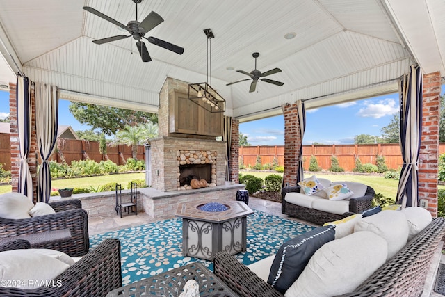 view of patio / terrace featuring an outdoor living space with a fireplace and ceiling fan