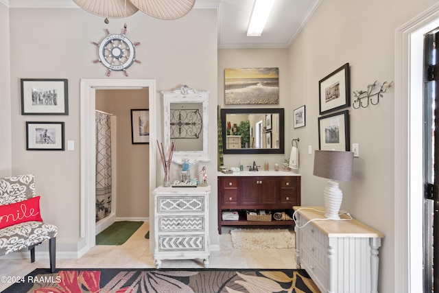 bathroom featuring walk in shower, vanity, tile patterned flooring, and crown molding