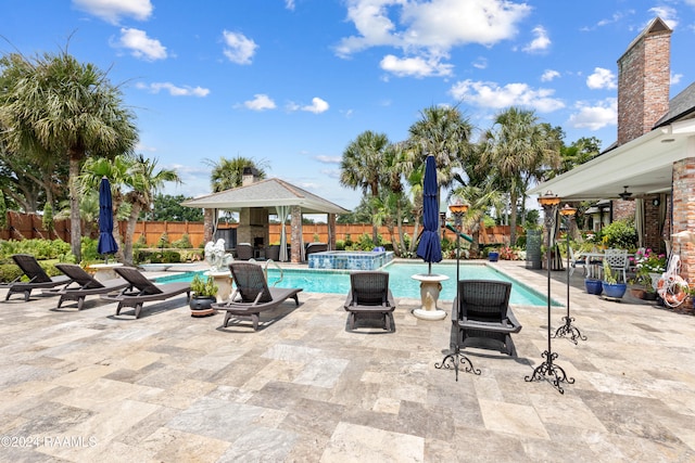 view of swimming pool with a patio area and an in ground hot tub