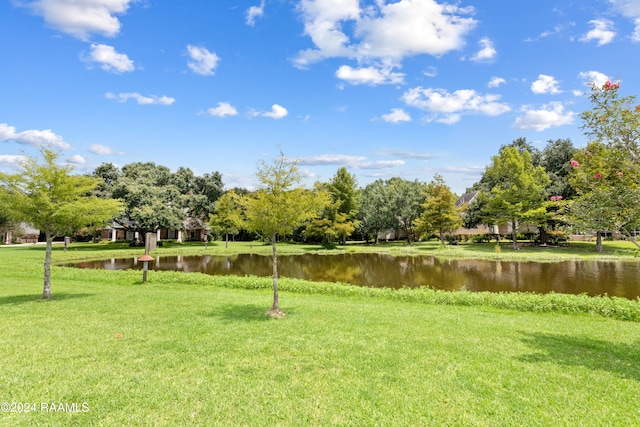 surrounding community featuring a water view and a yard