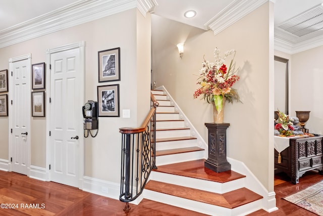 stairs with hardwood / wood-style flooring and crown molding