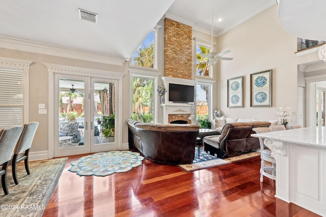 living room with wood-type flooring, french doors, ornamental molding, high vaulted ceiling, and ceiling fan