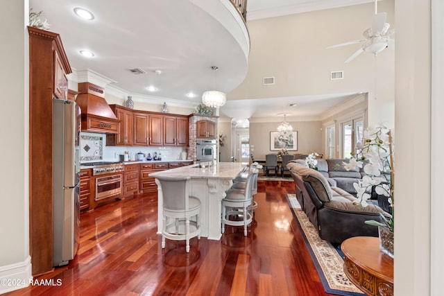 kitchen featuring stainless steel appliances, dark hardwood / wood-style floors, a breakfast bar, custom exhaust hood, and a center island