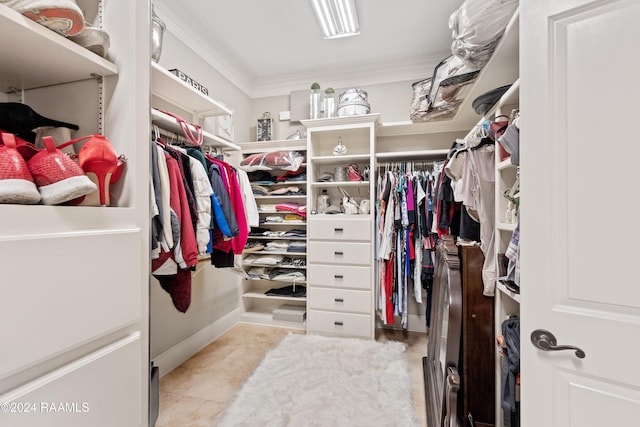 walk in closet with light tile patterned floors