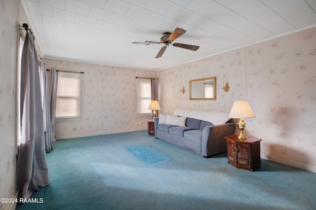 living room featuring crown molding, carpet, and ceiling fan