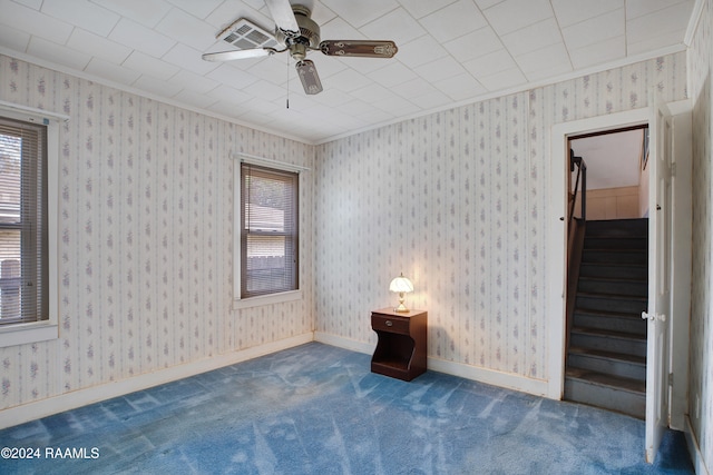 spare room featuring carpet floors, ceiling fan, and crown molding