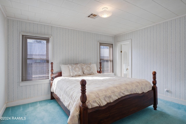 bedroom with carpet, ornamental molding, and multiple windows