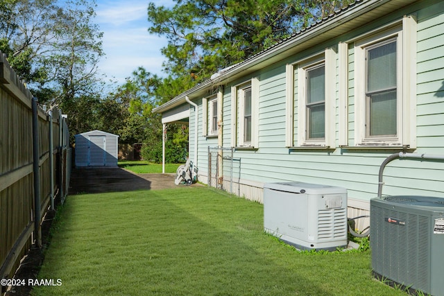 view of home's exterior with a storage unit, a yard, and central AC