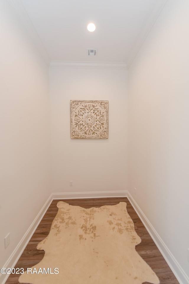 empty room featuring hardwood / wood-style floors and ornamental molding