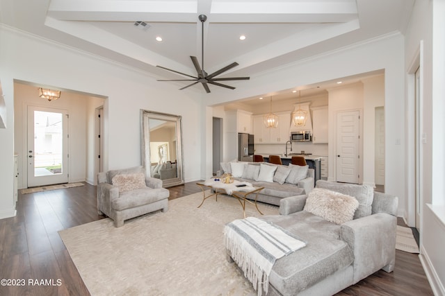 living room with dark hardwood / wood-style flooring, sink, ornamental molding, and ceiling fan with notable chandelier