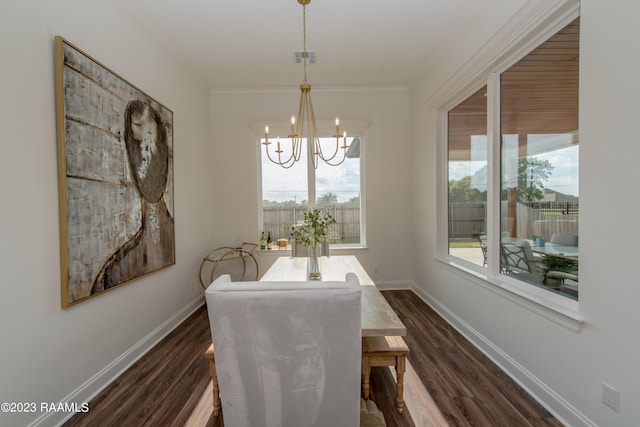 dining space featuring dark hardwood / wood-style flooring, a chandelier, and ornamental molding