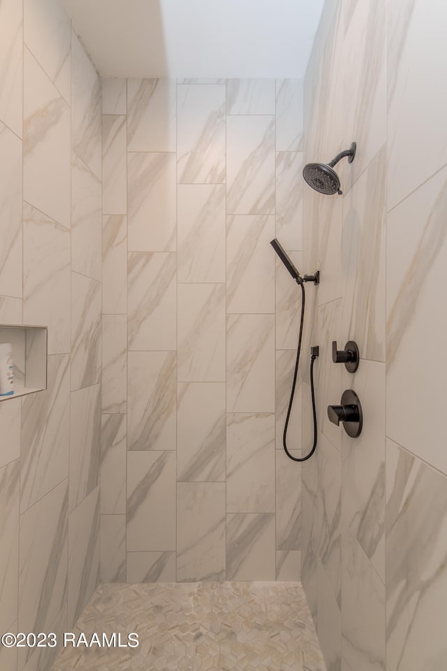 bathroom with a tile shower