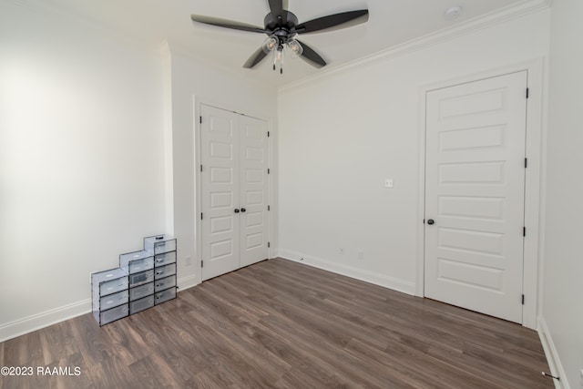 unfurnished bedroom featuring ornamental molding, dark hardwood / wood-style flooring, and ceiling fan